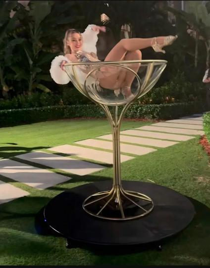 At Trump's Halloween party, a nearly naked woman posed in a chair designed to look like a martini glass.