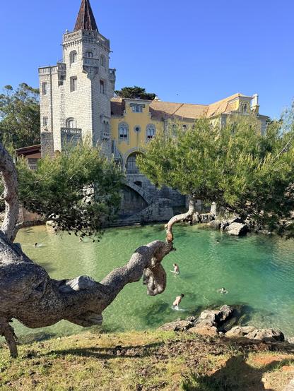 A castle -like building rises above an inlet.